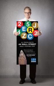 Pace Website_Our Work_ABS Partners_44 Wall Street_OOH Campaign_Man Holding Transit Poster